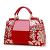 Embroidered lady's bag in patent leather